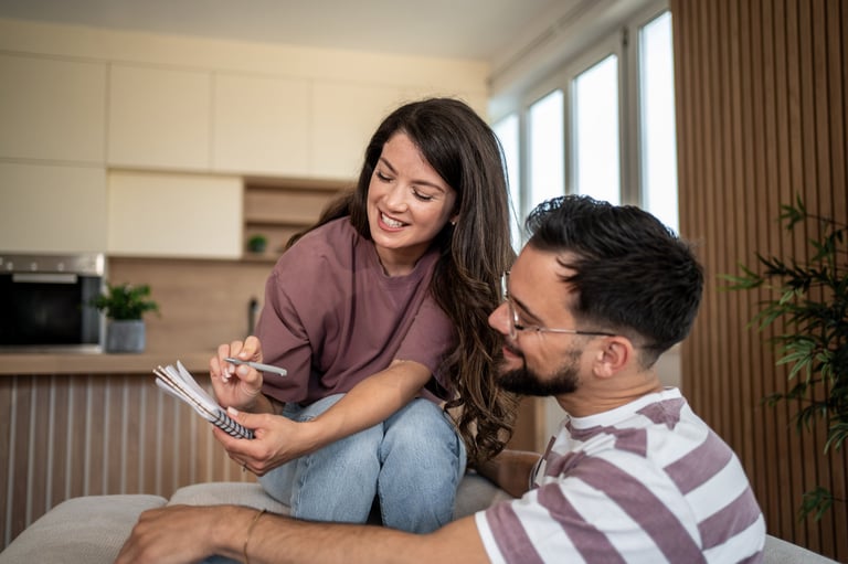 Two women discussing financial planning and credit review together at home with warm, hopeful atmosphere